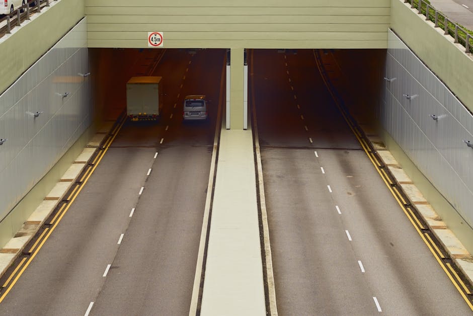 Aerial view of a highway tunnel with minimal traffic and clear lanes.